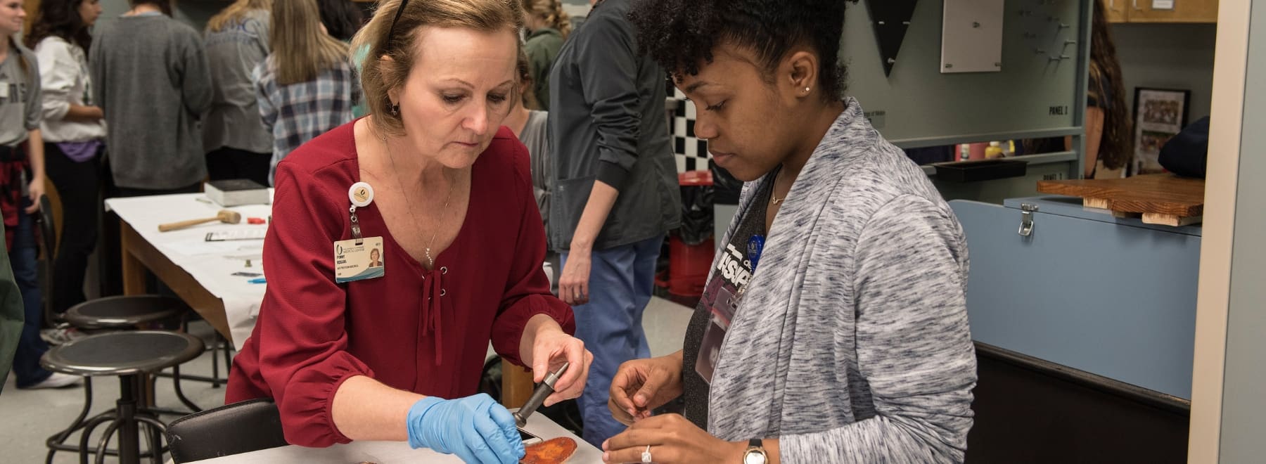 An OT student works closely with a faculty member to learn treatment skills